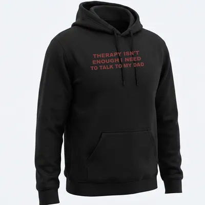 Bold typography shirt stating 'THERAPY ISN'T ENOUGH I NEED TO TALK TO MY DAD' in red on white. — printed on a unisex hoodie