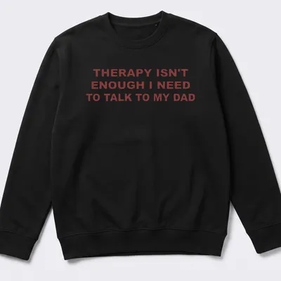 Bold typography shirt stating 'THERAPY ISN'T ENOUGH I NEED TO TALK TO MY DAD' in red on white. — printed on a unisex sweatshirt