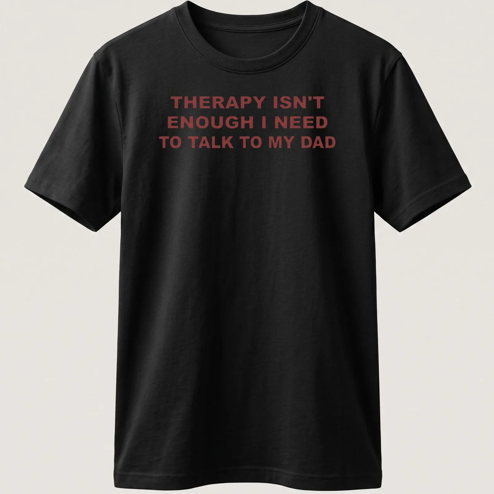 Bold typography shirt stating 'THERAPY ISN'T ENOUGH I NEED TO TALK TO MY DAD' in red on white. — printed on a unisex t-shirt