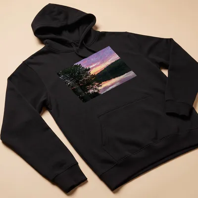 Photographic print of a serene lake at sunrise with colorful reflections and text. — printed on a unisex hoodie