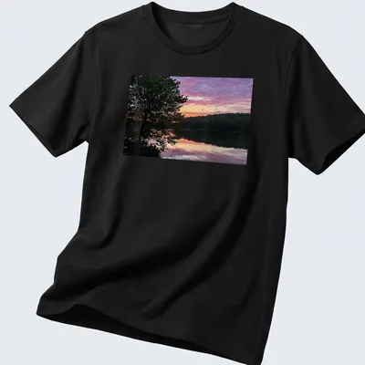 Photographic print of a serene lake at sunrise with colorful reflections and text.