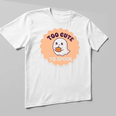 Kawaii ghost holding a pumpkin with text 'TOO CUTE TO SPOOK' — printed on a unisex t-shirt (angled view)