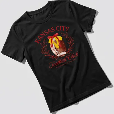 Kansas City Football Club t-shirt featuring a football and watercolor text design — printed on a women's shirt