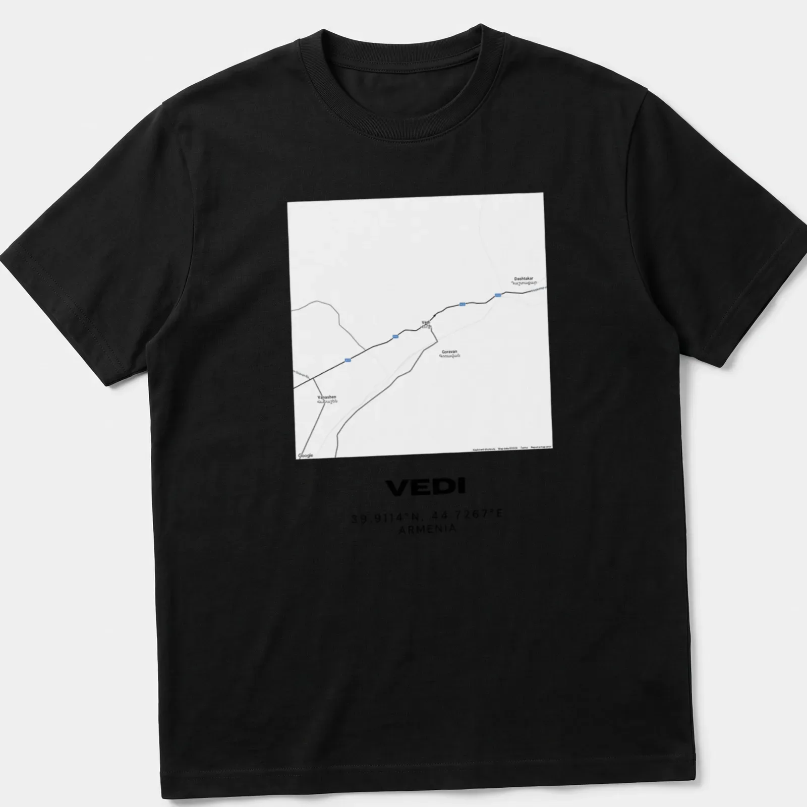 Minimalist T-shirt with a black and white map graphic of Vedi, Armenia, featuring coordinates — printed on a unisex t-shirt