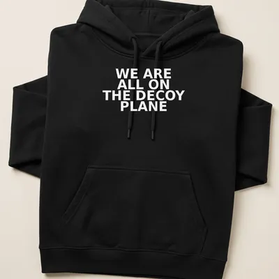 Bold typography t-shirt featuring the phrase 'WE ARE ALL ON THE DECOY PLANE' — printed on a unisex hoodie