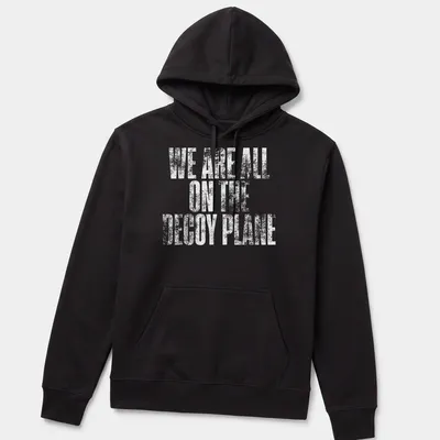 Distressed print of the phrase We Are All On The Decoy Plane in white — printed on a unisex hoodie