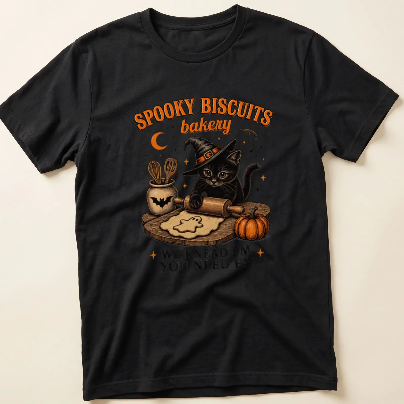 Vintage illustration of a black cat baking cookies with humorous text about spooky biscuits — printed on a unisex t-shirt