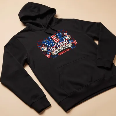 Colorful festive design featuring smiling faces and patriotic elements with text — printed on a unisex hoodie