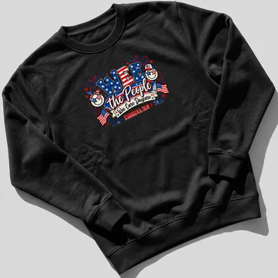 Colorful festive design featuring smiling faces and patriotic elements with text — printed on a unisex sweatshirt