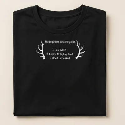 Vintage style shirt with antlers and humorous survival tips printed in black and white — printed on a women's shirt