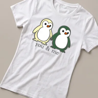 Cute cartoon of two penguins holding flippers with text above. — printed on a women's shirt